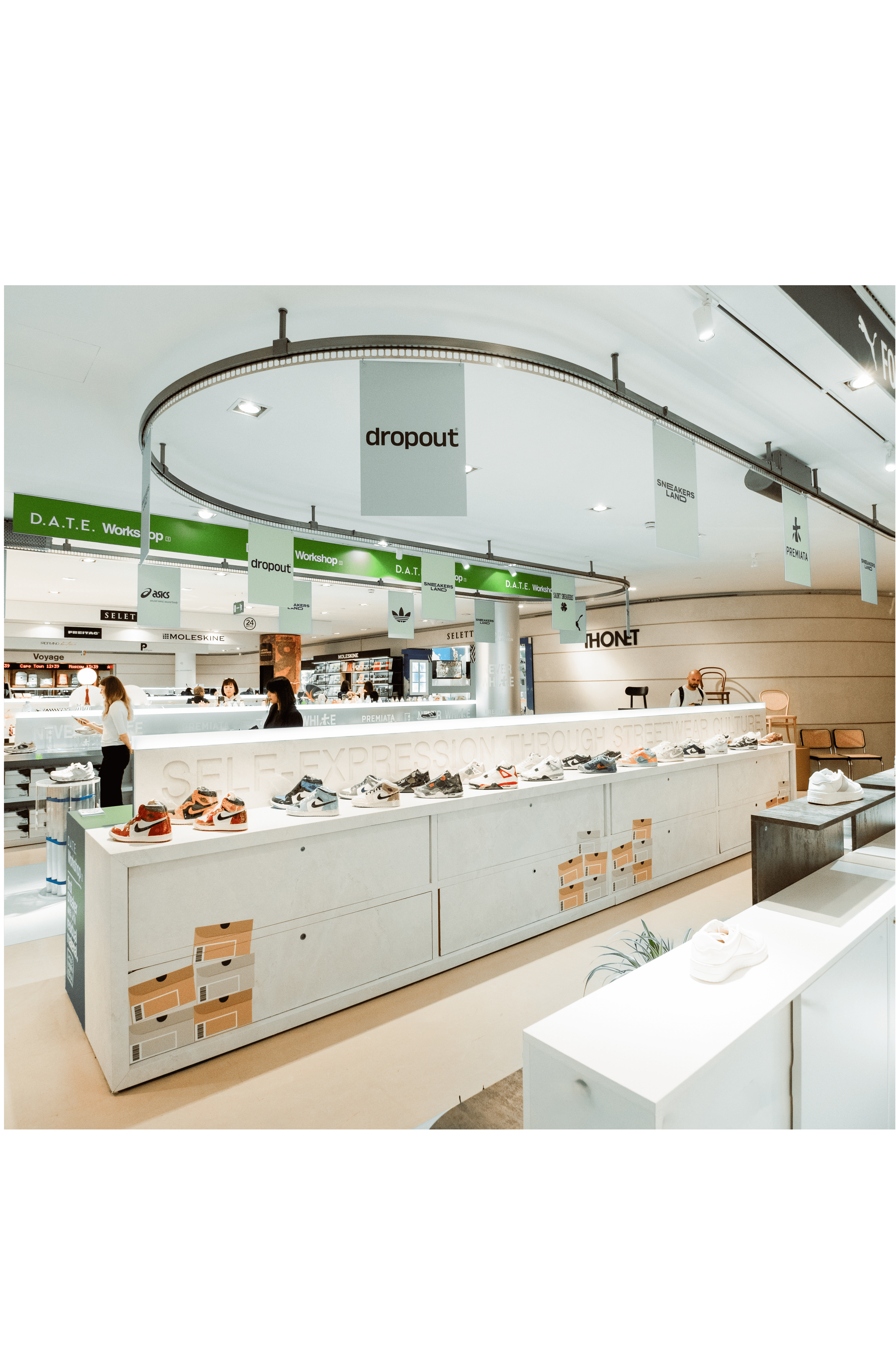 Modern retail shoe display featuring brands like Dropout and D.A.T.E in a stylish shopping environment.