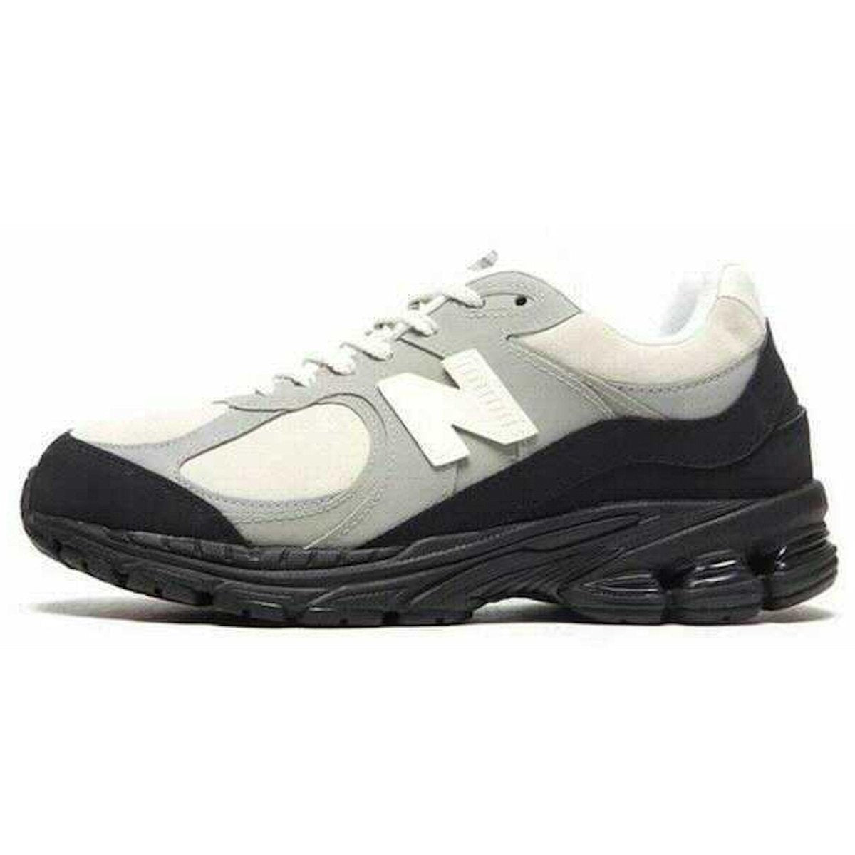 New Balance 2002R The Basement Grey Sail Black sneaker featuring premium suede and nubuck materials.