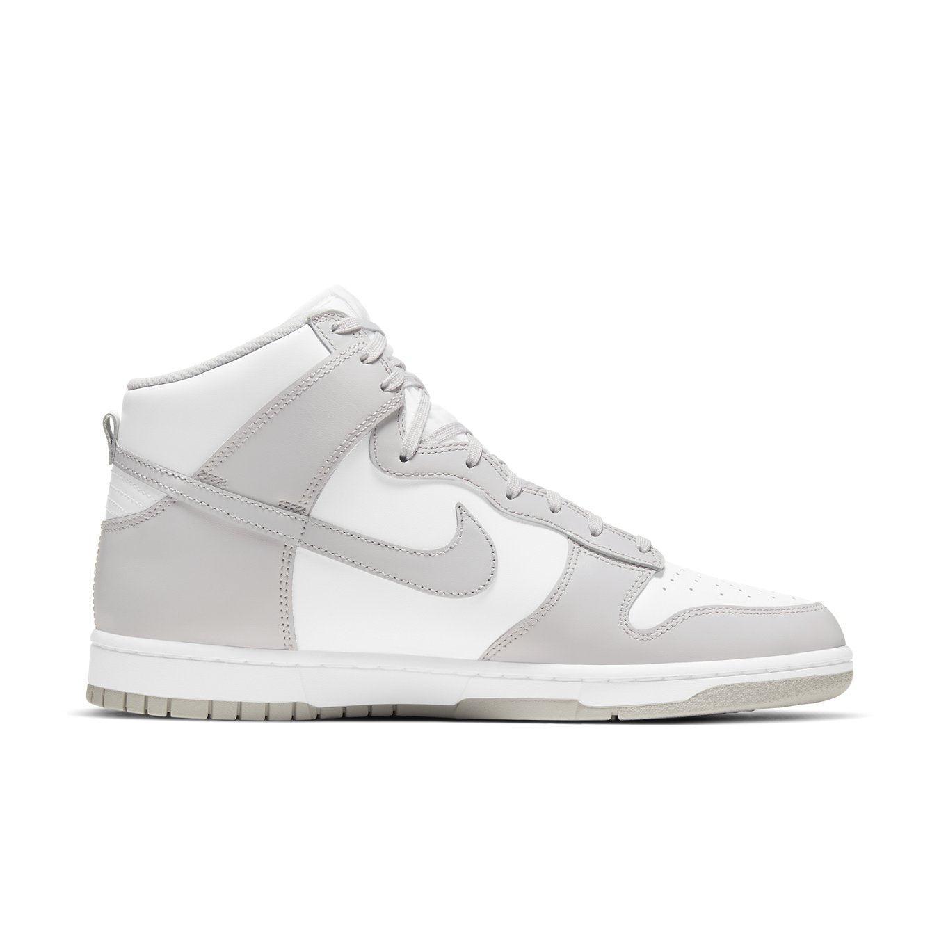 Nike Dunk High Retro in white and vast grey with a sleek high-top design, perfect for sport and street style.