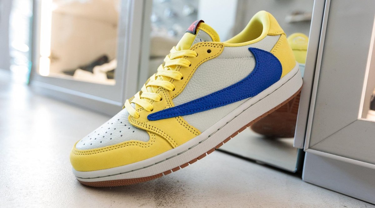 Jordan 1 Retro Low OG SP Travis Scott Canary women's sneaker in yellow and blue with stylish design details.