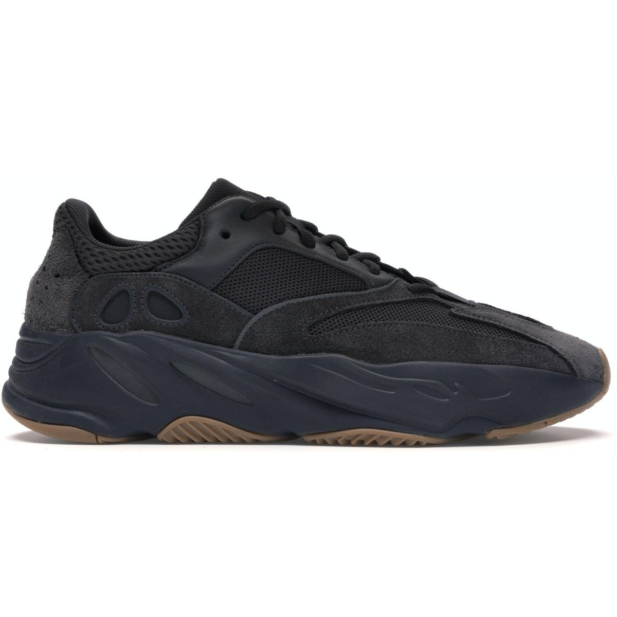 Adidas Yeezy Boost 700 Utility Black sneaker featuring a mesh upper and suede overlays, showcasing a sleek black design.