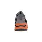 adidas Yeezy Boost 700 Wash Orange rear view showcasing sleek design and vibrant orange outsole.