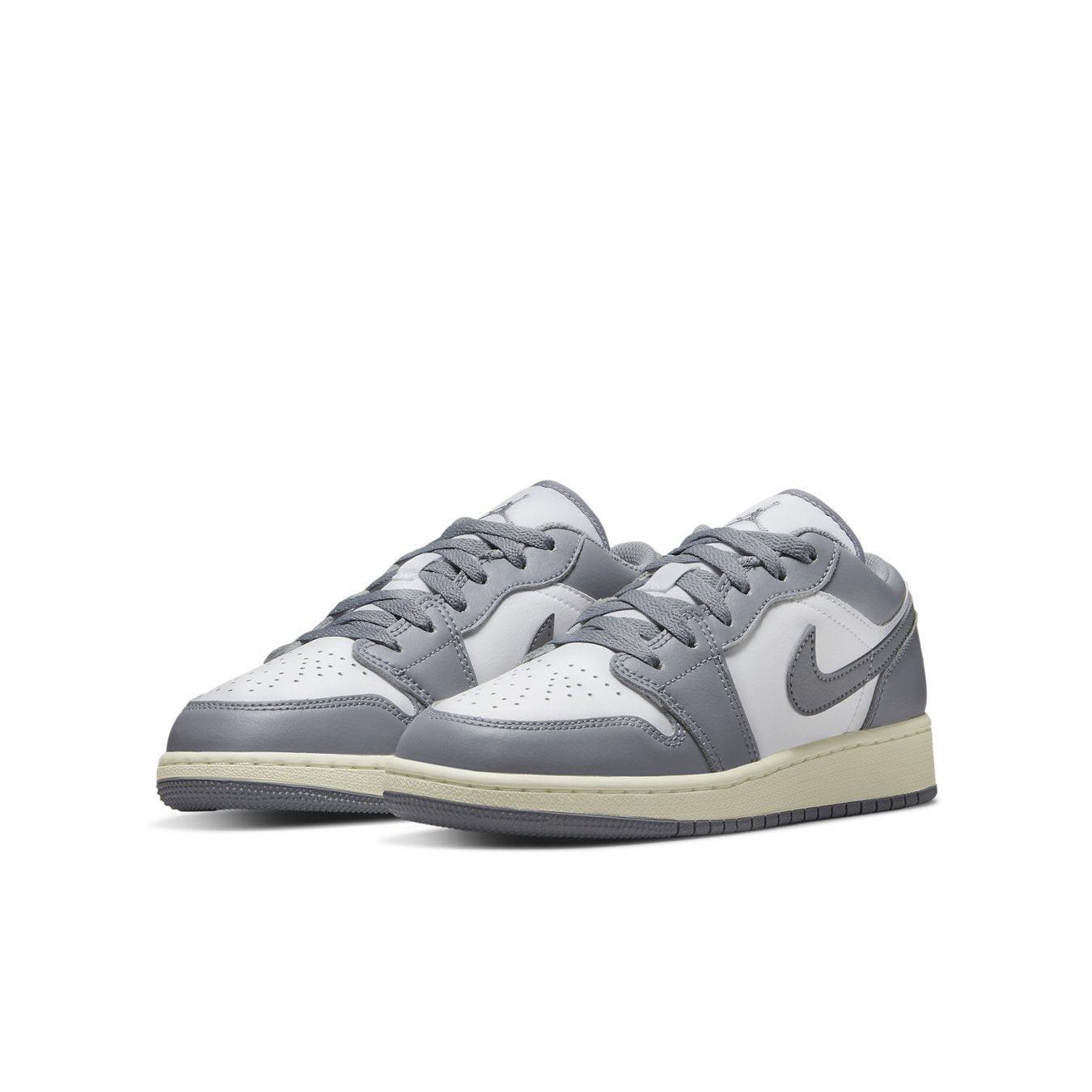 Air Jordan 1 Low Vintage Grey GS sneakers with leather upper in white and grey colorway, featuring classic design elements.