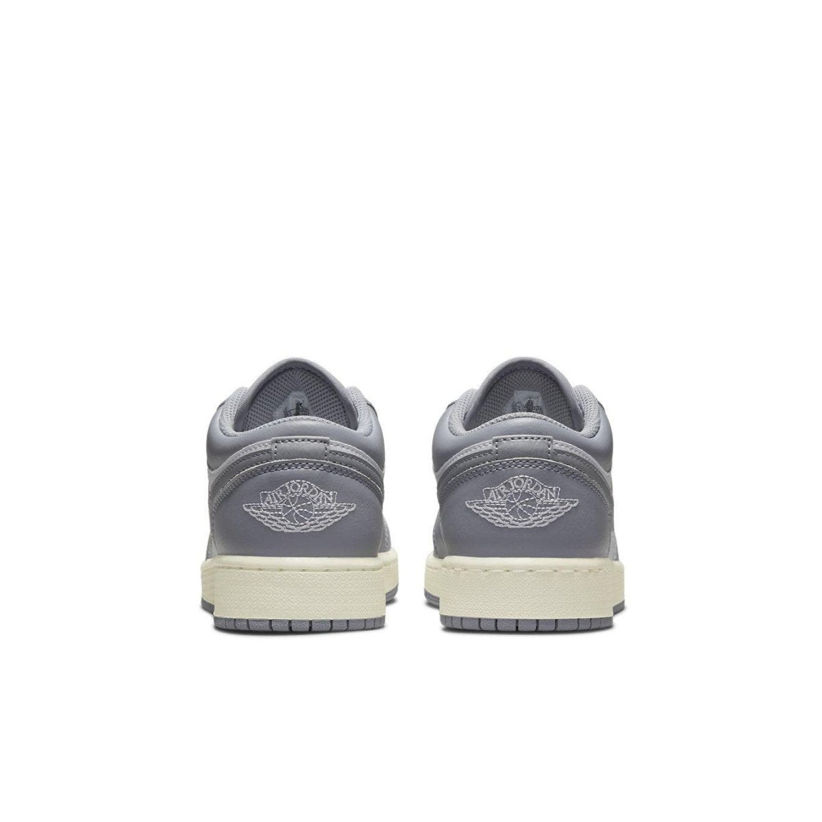 Air Jordan 1 Low Vintage Grey GS sneakers rear view with embroidered Wings logo and neutral colorway.