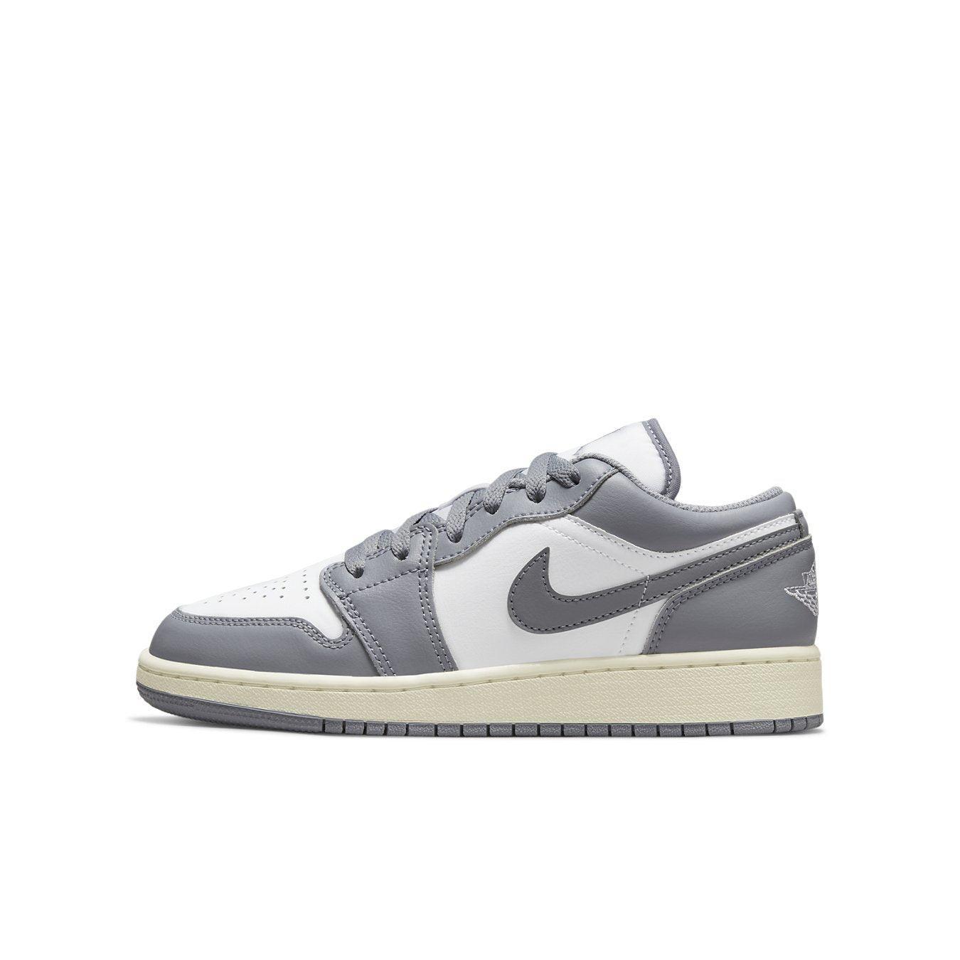 Air Jordan 1 Low Vintage Grey GS sneaker featuring a white and grey leather design with Jumpman logo.