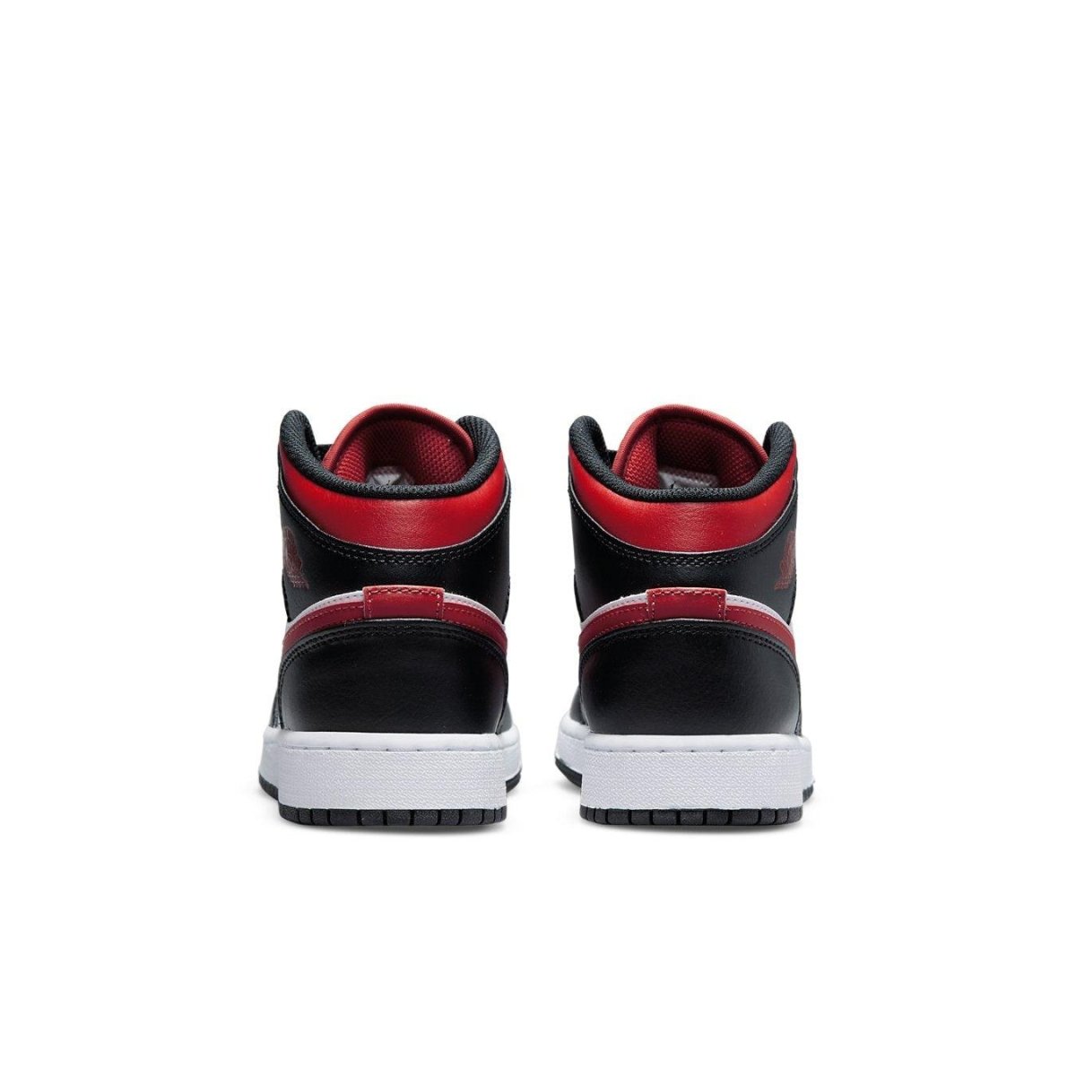 Air Jordan 1 Mid Black Fire Red (GS) sneakers rear view, showcasing black and red colorway with white sole.