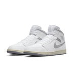 Air Jordan 1 Mid Neutral Grey featuring white leather with grey Swoosh, perfect for sporty fashion.