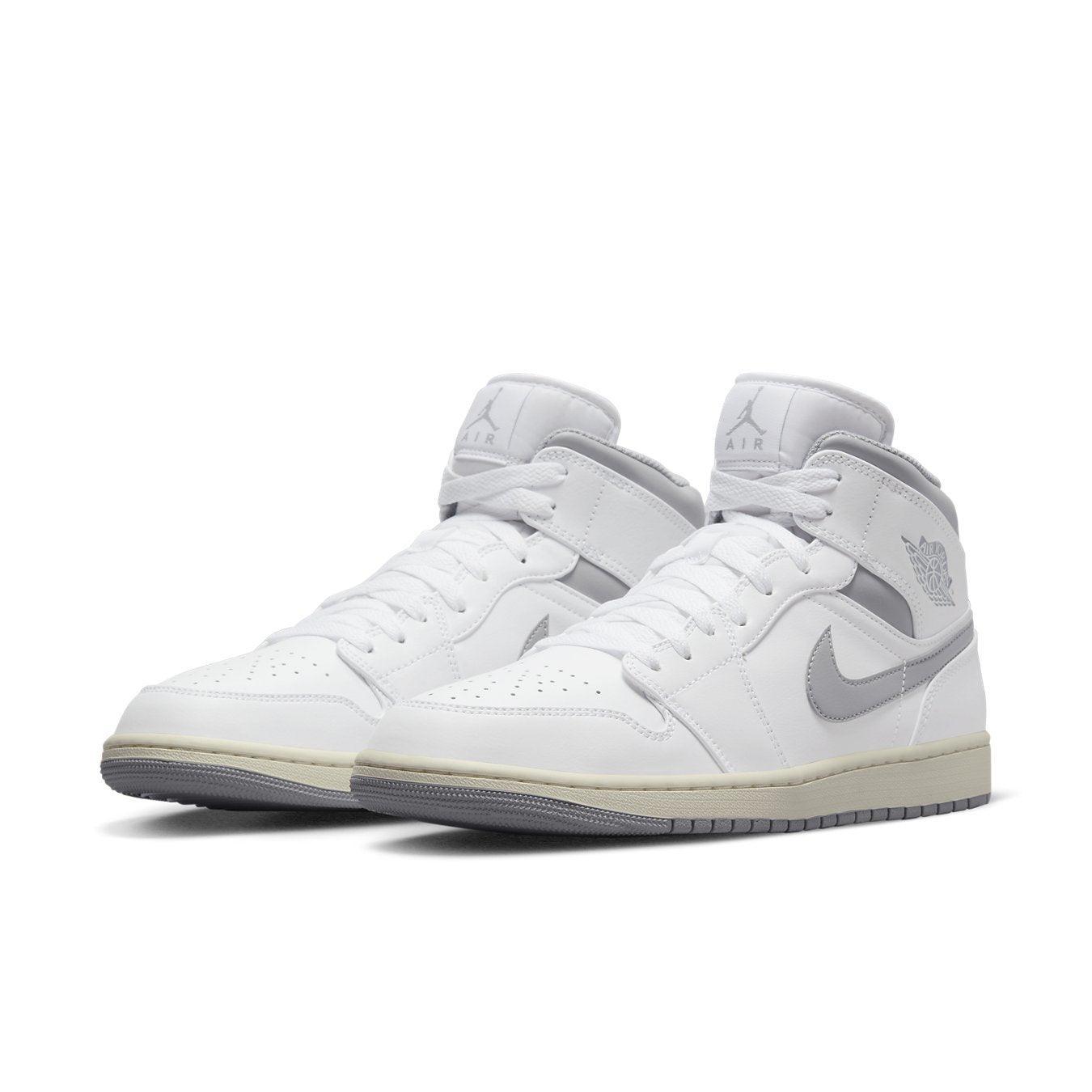 Air Jordan 1 Mid Neutral Grey featuring white leather with grey Swoosh, perfect for sporty fashion.