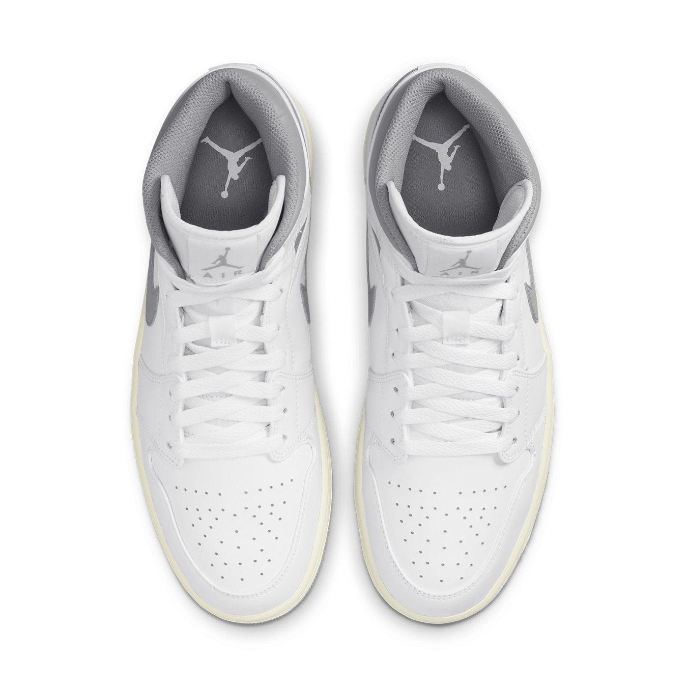 Air Jordan 1 Mid Neutral Grey, featuring a white leather upper and Neutral Grey accents, top view.