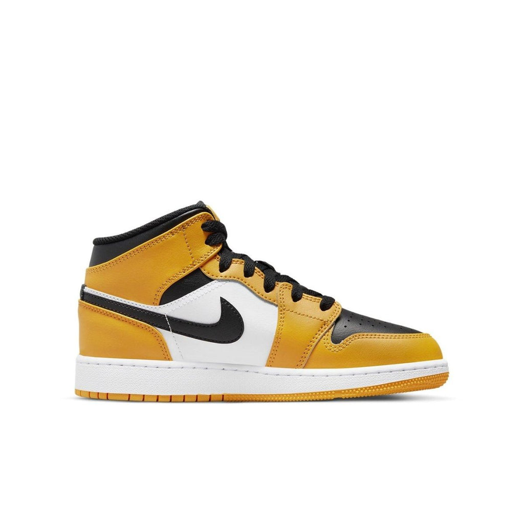 Air Jordan 1 Mid Taxi GS sneakers in white, black, and yellow leather, featuring a stylish mid-top design.