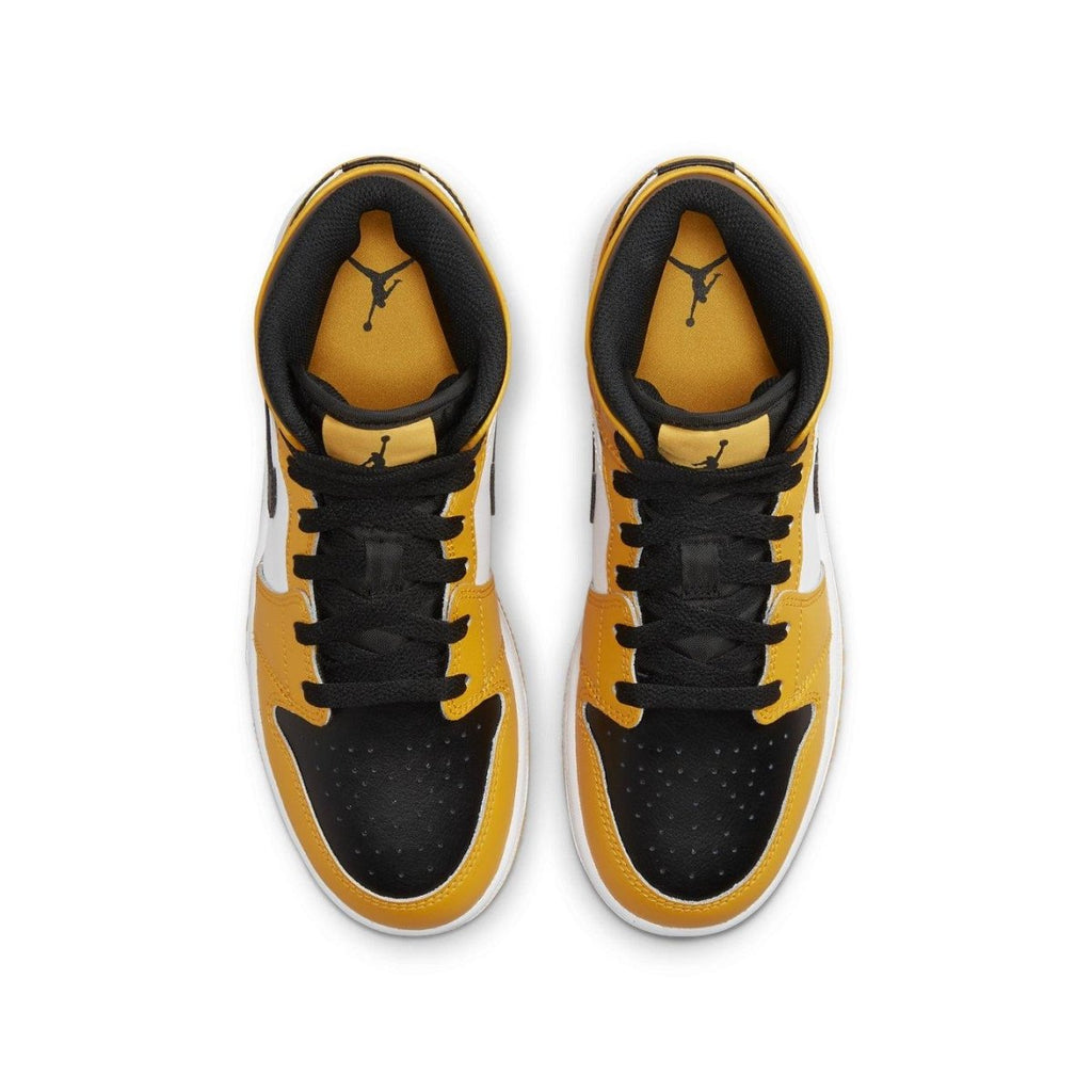 Air Jordan 1 Mid Taxi (GS) sneakers with black, white, and yellow leather upper from top view.