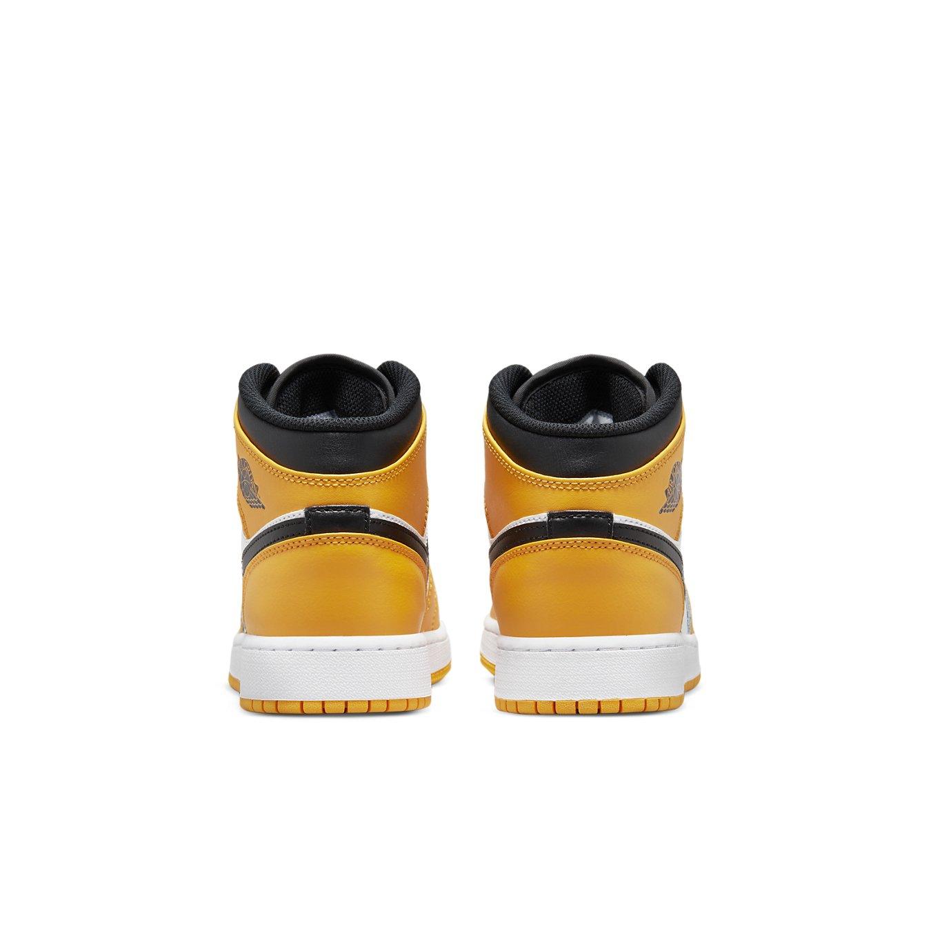 Air Jordan 1 Mid Taxi GS sneakers featuring black and yellow leather design with white soles and rear view.