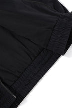 Close-up of the Black/Red NPT Baby Gang Zip Track Top, showcasing the elastic waistband and fabric details.