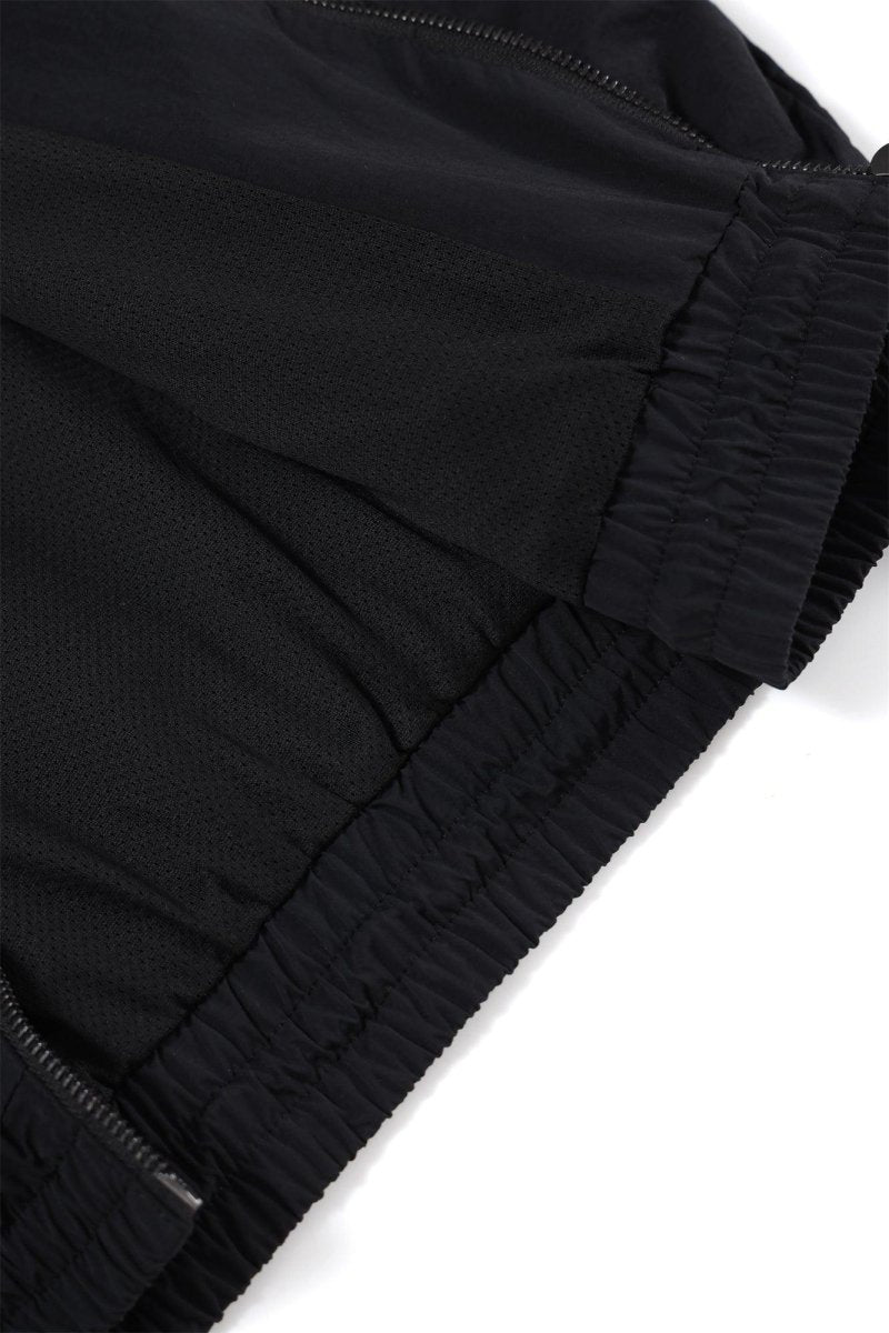 Close-up of the Black/Red NPT Baby Gang Zip Track Top, showcasing the elastic waistband and fabric details.