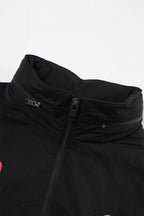 Close-up of the collar and zipper of the Black/Red NPT Baby Gang Zip Track Top jacket.