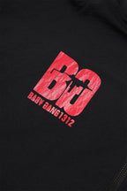 Close-up of the black and red logo on the Black / Red NPT Baby Gang Zip Track Top, featuring stylized 'BG' lettering.