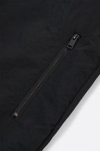 Close-up of the black zip on the Black / Red NPT Baby Gang Zip Track Top jacket.