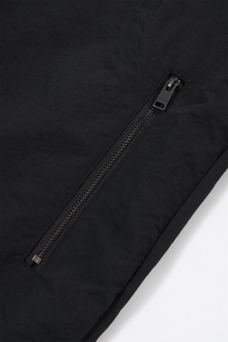 Close-up of the black zip on the Black / Red NPT Baby Gang Zip Track Top jacket.