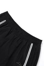 Black and white NPT Baby Gang zip track pants showcasing elastic waistband and zipper details.