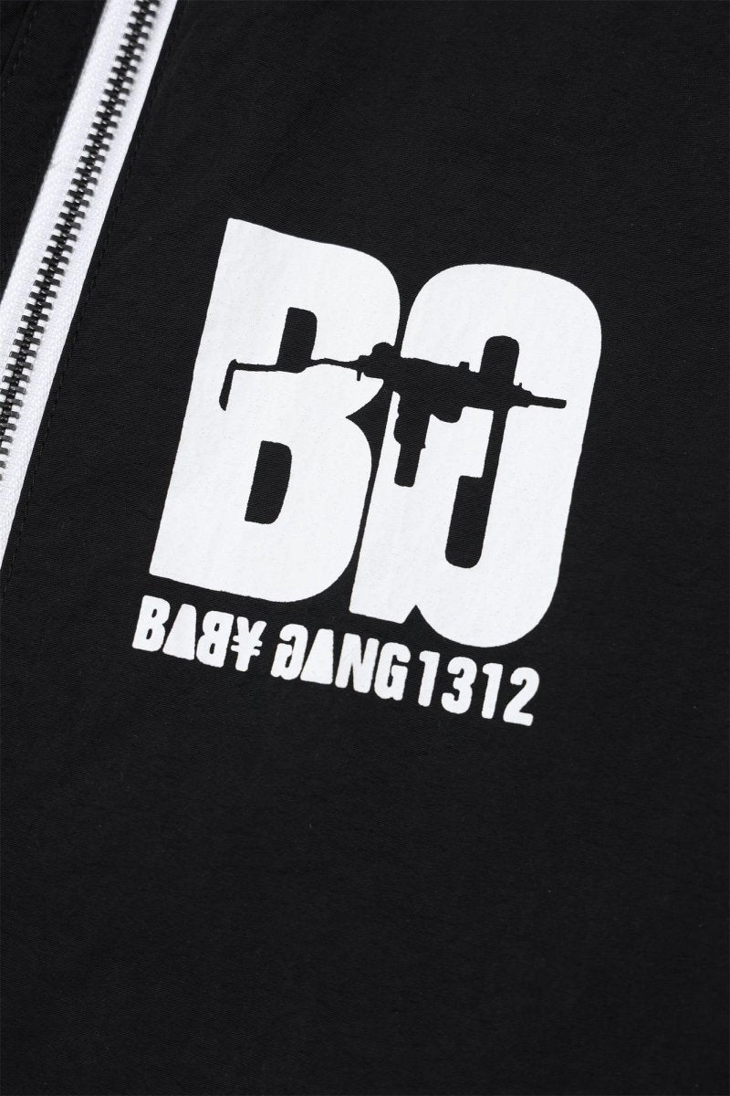 Detail of Black/White Baby Gang zip track pants featuring bold logo and design.