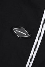 Close-up of the logo on the Black/White NPT Baby Gang Zip Track Pants by Unknown, featuring a sleek design.