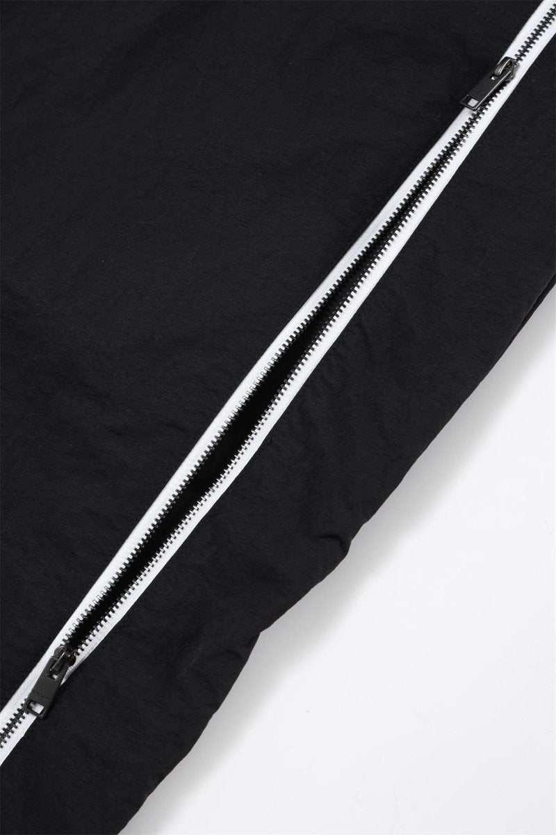 Close-up of the zipper detail on Black/White NPT Baby Gang zip track pants, showcasing fabric texture.