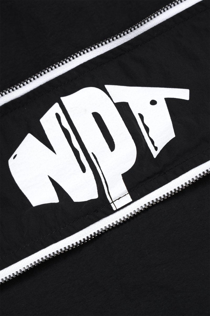 Close-up of the NPT logo on the Black/White Baby Gang Zip Track Top, showcasing stylish design and details.