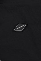 Detail of Black NPT Baby Gang Zip Track Top showing the logo patch on the fabric in a close-up view.