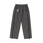 Grey and black NPT Simba La Rue zip track pants featuring a stylish design and elastic waistband for comfort.