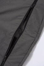 Close-up of the grey and black zip detailing on NPT Simba La Rue track pants, showcasing high-quality fabric and design.