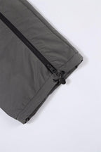 Detail of Grey and Black NPT Simba La Rue Zip Track Pants showcasing zipper and fabric texture.