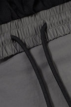 Close-up of the waistband and drawstrings of Grey/Black NPT Simba La Rue Zip Track Pants, showcasing the fabric texture.