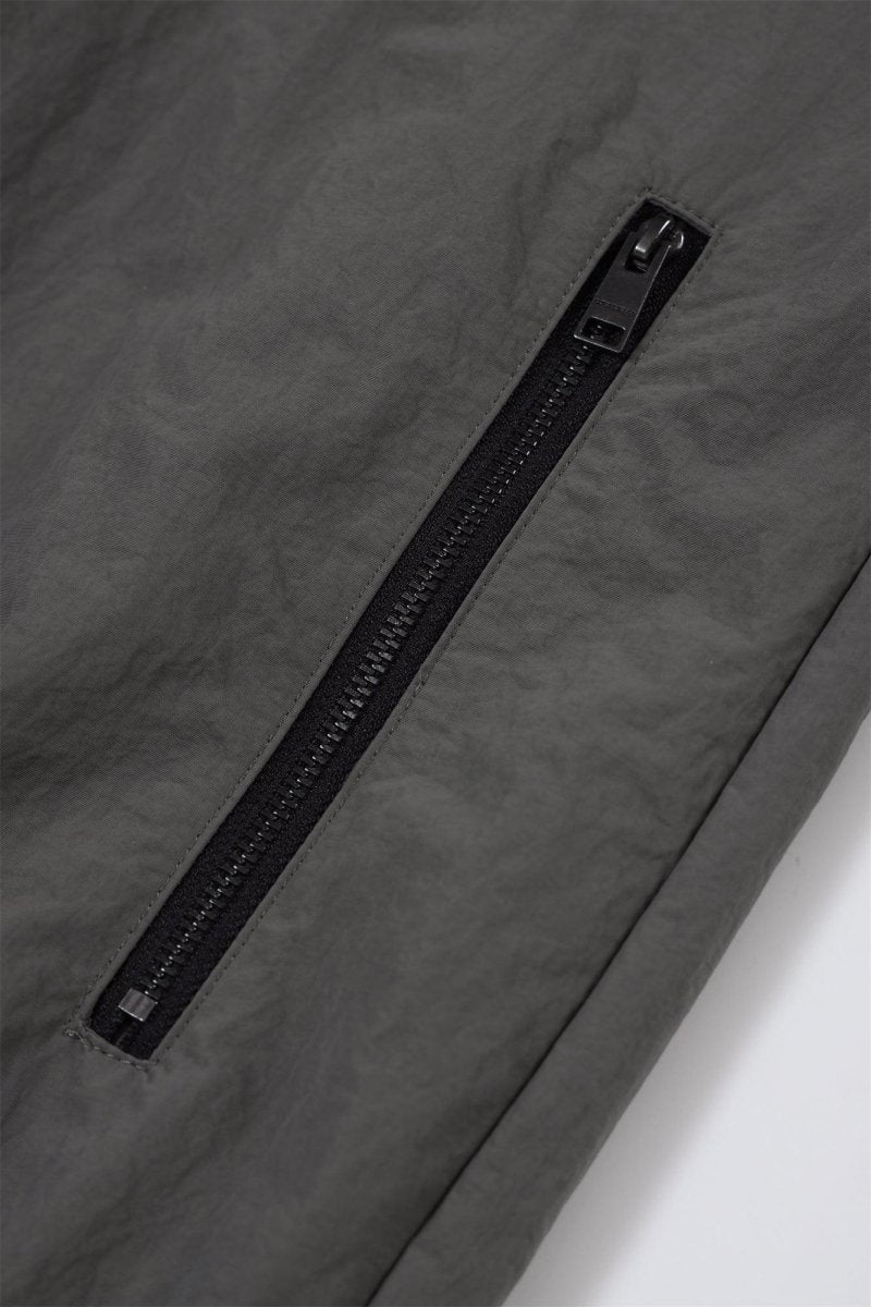 Close-up of the zip detail on the Grey/Black NPT Simba La Rue Zip Track Top, showcasing a sleek black zipper.