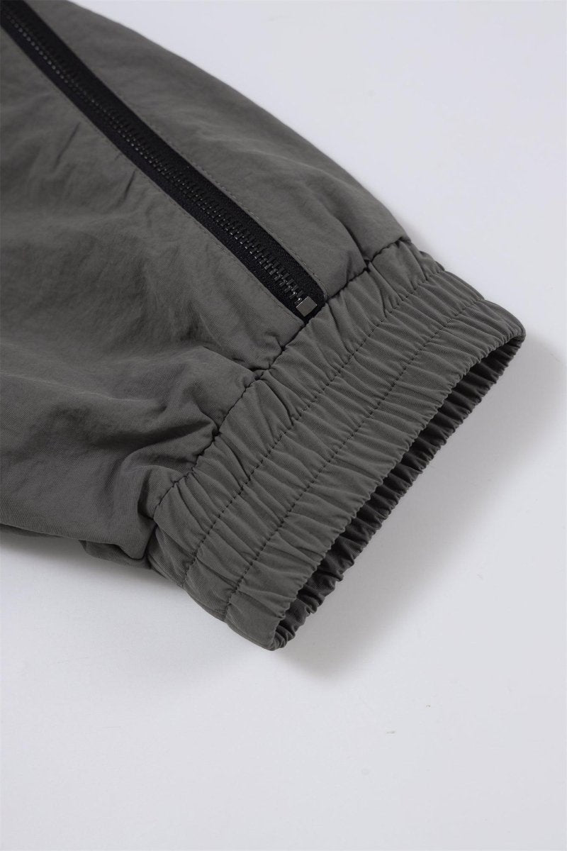 Close-up of the cuff detail on a grey/black NPT Simba La Rue zip track top, showcasing its elastic finish and zipper.