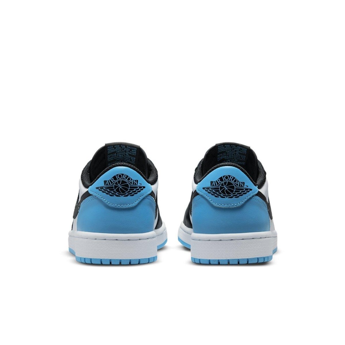 Back view of Air Jordan 1 Low in black and dark powder blue, showcasing premium suede and Jumpman logo.