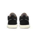 Jordan 1 Low Black Guava Ice (W) rear view showcasing black and beige suede with signature logo detail.
