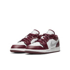 Air Jordan 1 Low Bordeaux GS shoes in burgundy and white with a stylish design and Nike Swoosh.