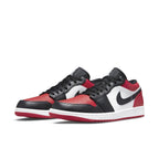 Air Jordan 1 Low Bred Toe sneakers featuring black, red, and white color scheme with iconic logo.