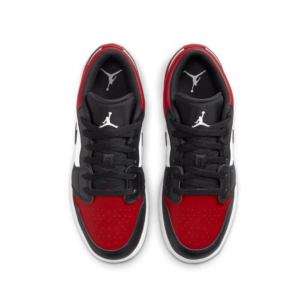 Jordan 1 Low Bred Toe (GS) sneakers featuring red, black, and white colorway with iconic Air Jordan logo.