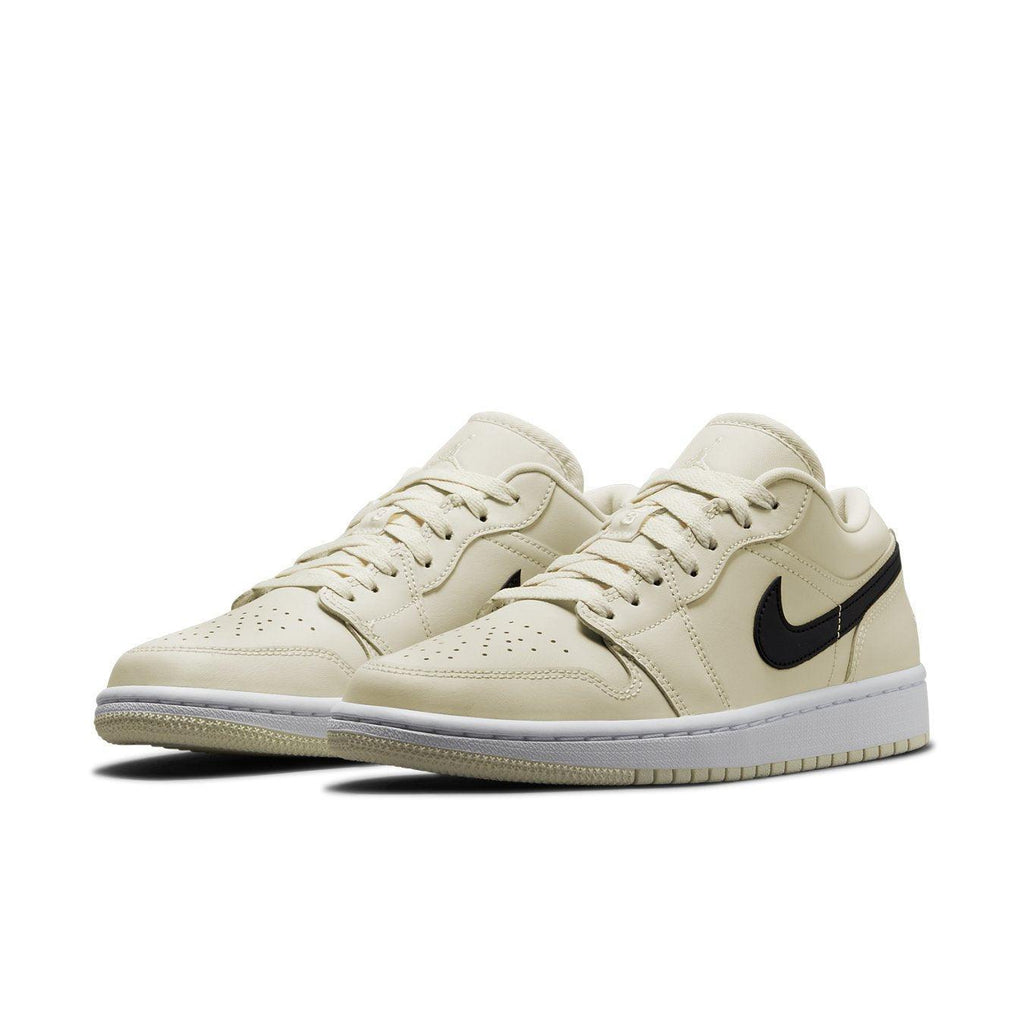 Air Jordan 1 Low Coconut Milk sneakers in creamy white with black Nike logo and lace details.