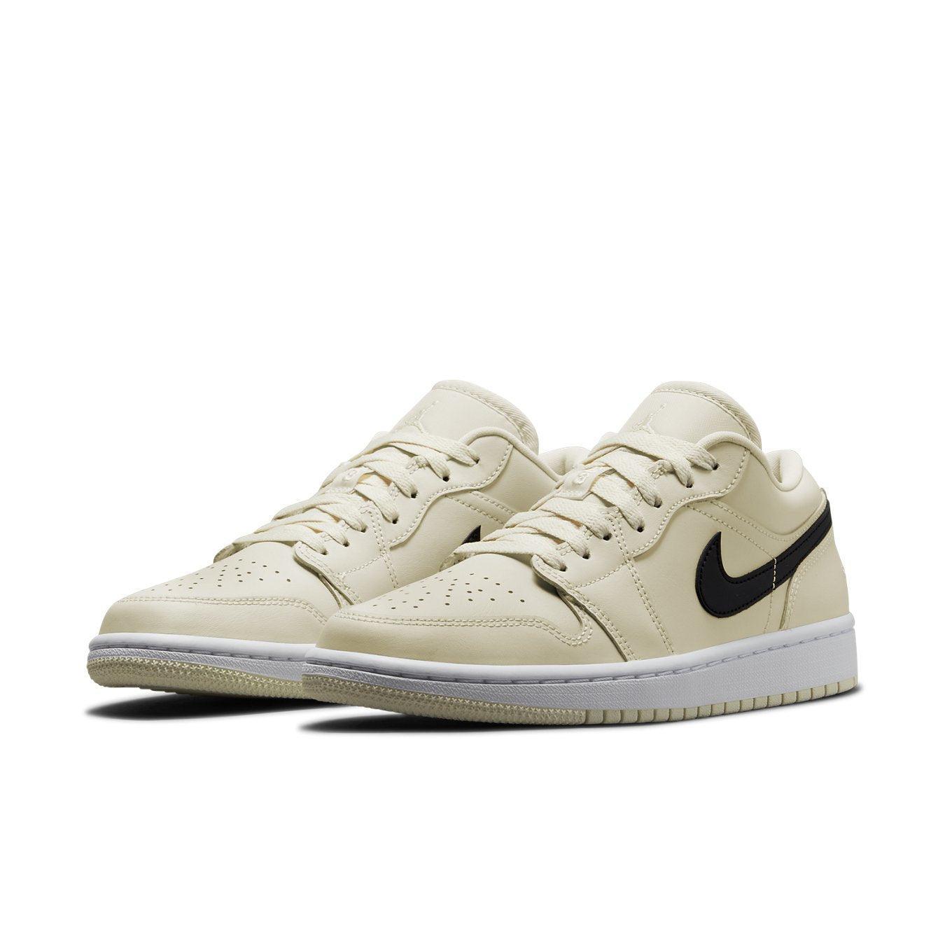 Air Jordan 1 Low Coconut Milk sneakers in creamy white with black Nike logo and lace details.