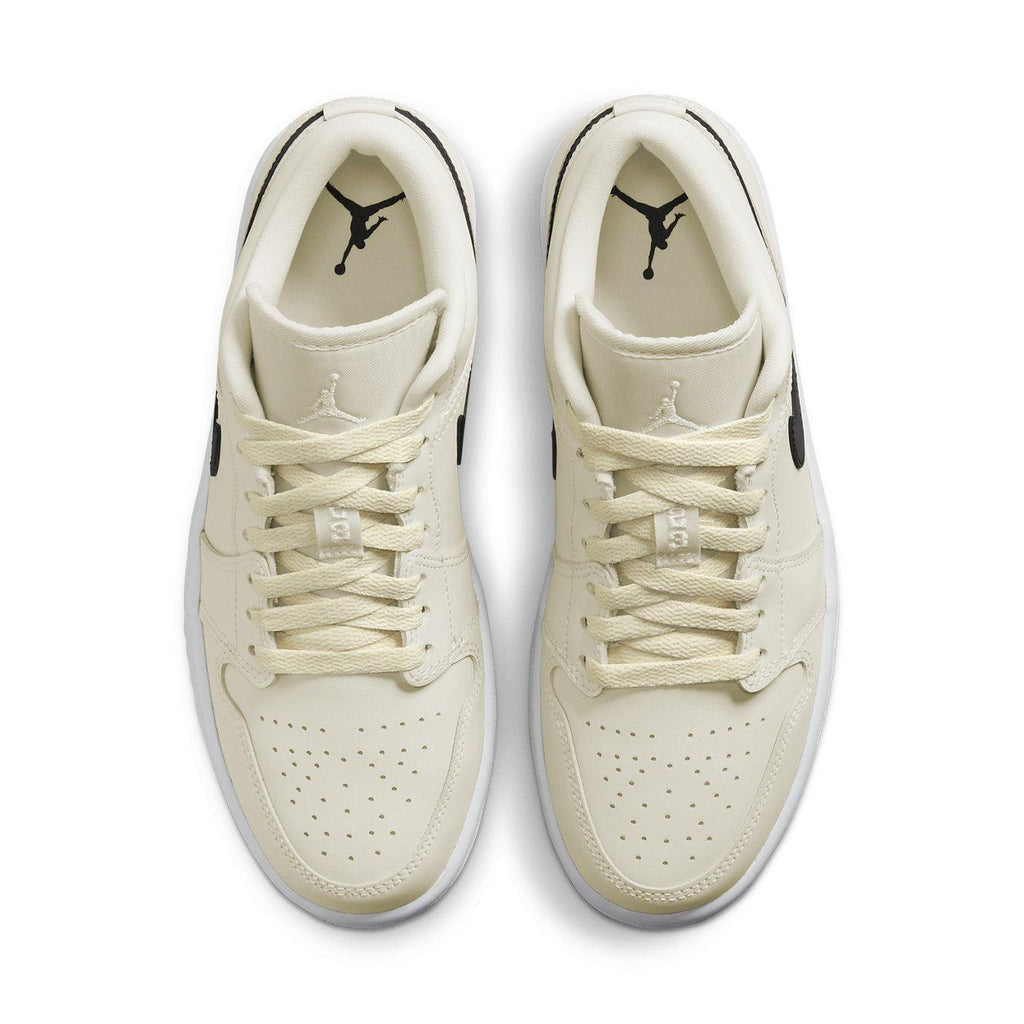Air Jordan 1 Low Coconut Milk women's shoes with cream upper and black accents, showcasing stylish design from above.