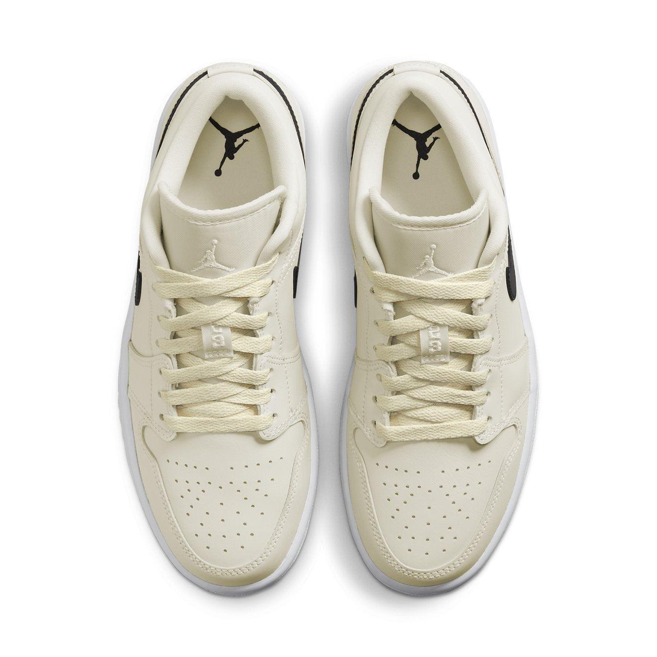 Air Jordan 1 Low Coconut Milk women's shoes with cream upper and black accents, showcasing stylish design from above.