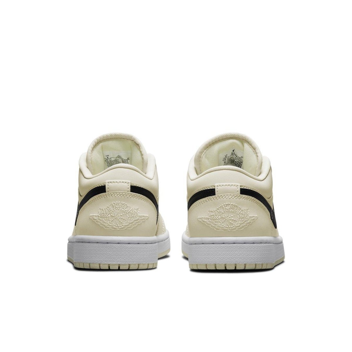 Retro Air Jordan 1 Low Coconut Milk sneaker in cream color with black accents and iconic logo on heel.