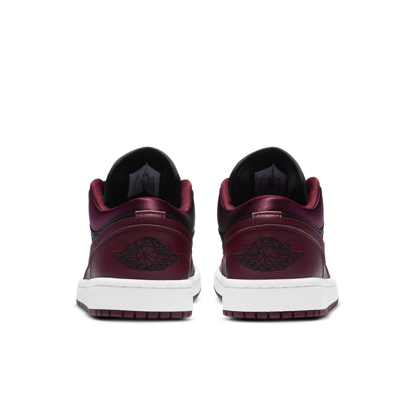 Back view of Jordan 1 Low Dark Beetroot Black women's sneakers, featuring maroon leather and white sole.