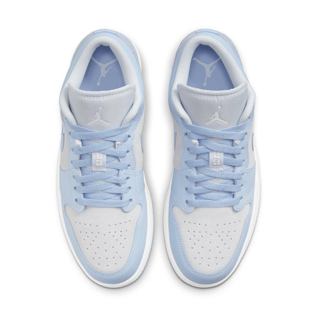 Air Jordan 1 Low UNC in white leather with light blue accents, featuring a Jumpman logo and navy details.