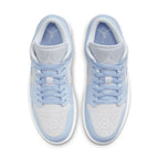 Air Jordan 1 Low UNC in white leather with light blue accents, featuring a Jumpman logo and navy details.