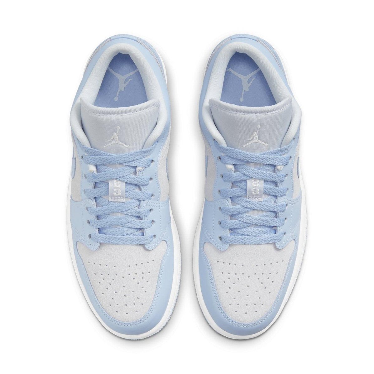 Air Jordan 1 Low UNC in white leather with light blue accents, featuring a Jumpman logo and navy details.