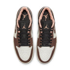 Air Jordan 1 Low Mocha shoes featuring a white base, brown suede overlays, and pink accents on the tongue and collar.