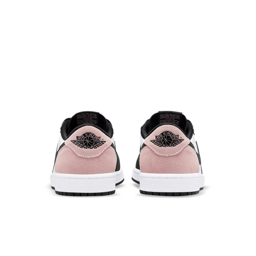 Rear view of Jordan 1 Low OG Bleached Coral showcasing black and bleached coral suede details and logo.